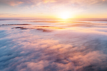 Fototapeta na wymiar Fantastic scene of plain in the fog from a bird's eye view. Drone shot.