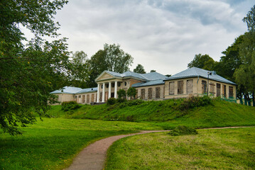 Obraz premium Green meadow and ruins of estate in Park Mon Repos, Vyborg, Russia