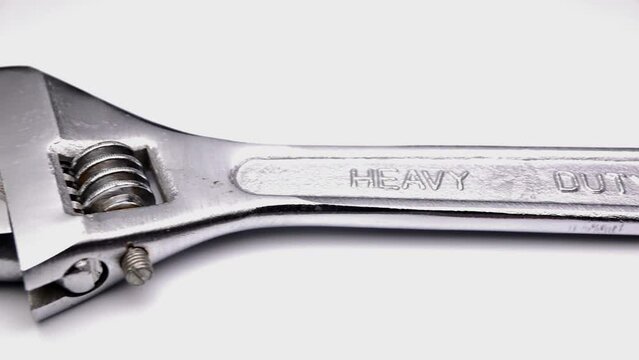 sliding footage of adjustable wrench on white