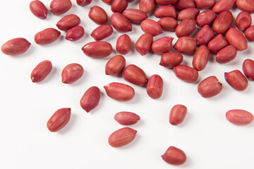 red peeled peanuts isolated on white background.