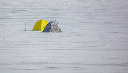 Two fisherman's tents on the ice in winter.