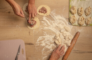 Cooking dough with meat on the table.