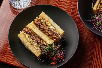 beef sandwich in a plate on a wooden background