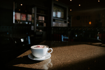 peppermint latte in a cozy coffee shop with the sun streaming th