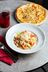 caesar salad with chicken in a white plate. restaurant menu.