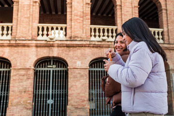 Valencia, spain, young mother and teen daughter walking around t