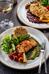 grilled fish with side dish, vegetables and herbs