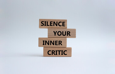 Silence your inner critic symbol. Wooden blocks with words Silence your inner critic. Beautiful white background. Business and Silence your inner critic concept. Copy space.