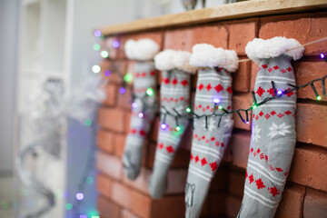 Brick fireplace with Christmas socks and Christams lights