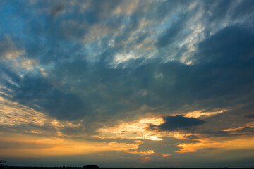 Bright dramatic sky with clouds at sunset