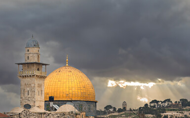 Golden dome of Mosque on Temple Mounts in Jerusalem, sunbeams just before a dust storm
