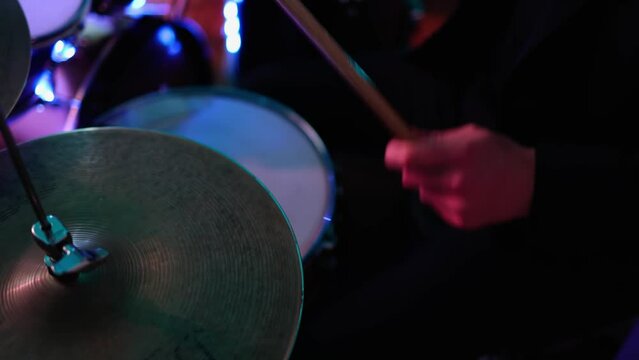  man plays a drum kit,Music party,colored lights