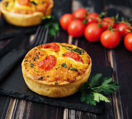 Cheddar cheese and spring onion omelette tarts served on wooden board