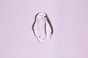 facial gel cosmetics texture on a pink background, moisturizing and cleansing