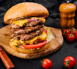 Giant hamburger fast food cutlet on wooden board