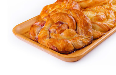 Buns with berry jam on wooden plate