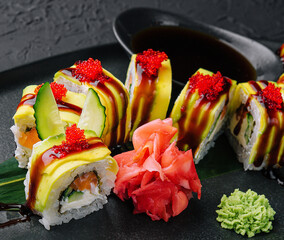 Green dragon sushi roll with eel on black stone