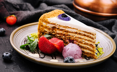 piece of multi-layered cake decorated with mixed berries