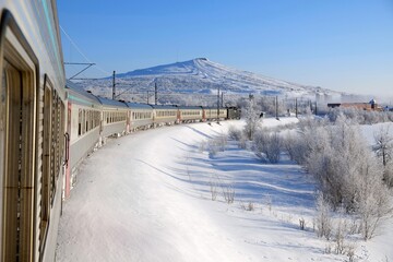 Fototapeta premium Polar Express in Kiruna in winter scenery. Kiruna is city with iron ore mine. Sweden, Arctic Circle, Swedish Lapland