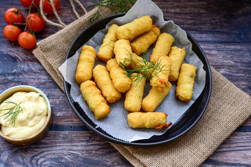  Traditional fried  Potato Croquettes with Cheese  dipping sauce on wooden board