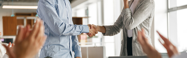 Close up of boss leader shaking hand of new team member recruiting him for job on staff briefin - obrazy, fototapety, plakaty