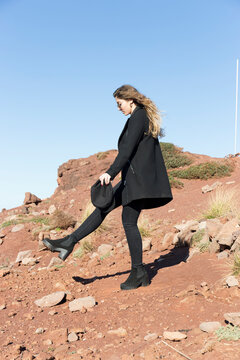 Full length of young woman at beach against clear sky