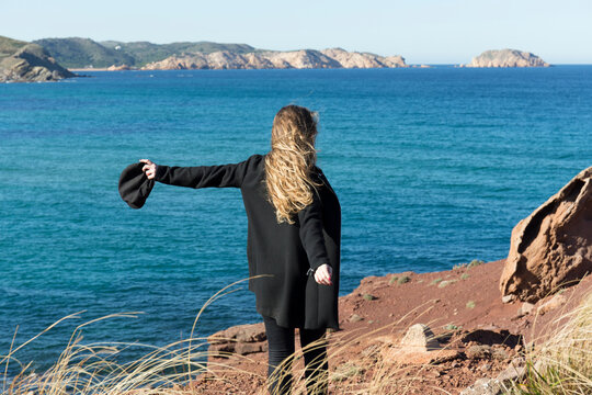 Young woman looking at view while standing on shore