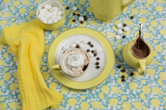 High angle view of hot drink with whipped cream served on table