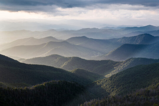 Scenic view of mountains against cloudy sky