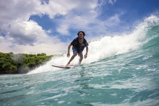 Low angle view of man surfing on sea against sky