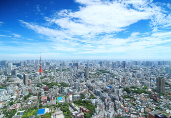 Aerial view of cityscape against cloudy sky during sunny day