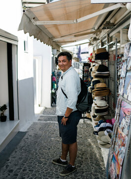 Side view portrait of tourist standing on footpath at market in town