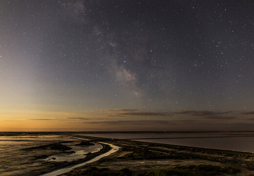 Scenic view of salt flat against star field during dusk