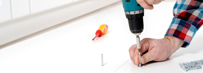 furniture assembly master assembles the cabinet