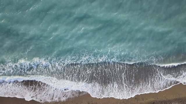 plage de galets en vue a&eacute;rienne	avec le ressac des vagues