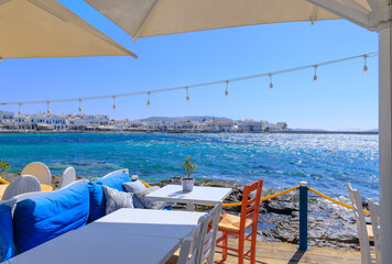 Skyline of the Mykonos town in Greece: view of the harbor from a typical restaurant on the seashore.
