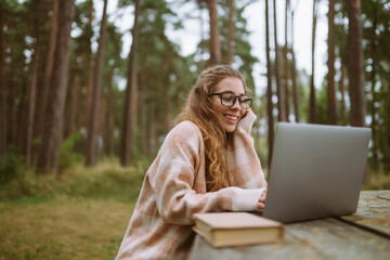 Young woman with laptop outdoor. Education online. Freelancer, Business, shopping, blogging, online video conference.