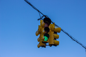 Yellow American traffic lights suspended with cables