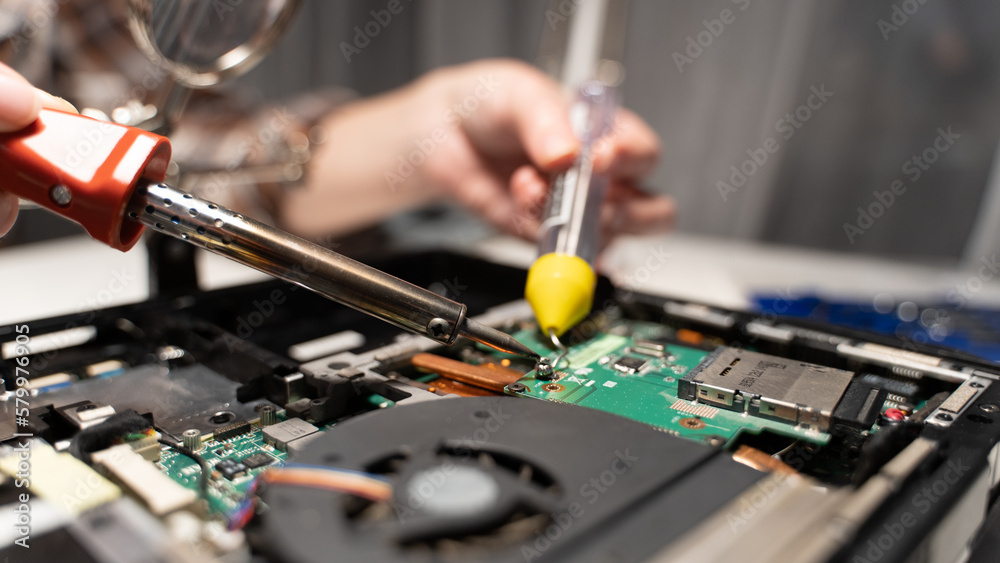 Wall mural computer repairman soldering the board with a soldering iron