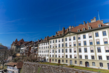 Fototapeta na wymiar Scenic view of historic houses at the old town seen from Minster Terrace at the Swiss City of Bern on a sunny winter day. Photo taken February 21st, 2023, Bern, Switzerland.