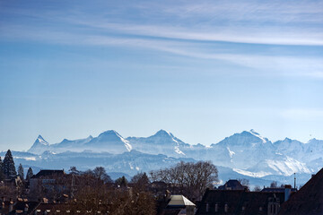 Scenic view of skyline at City of Bern with peaks of the Bernese Alps in the background on a sunny...
