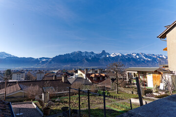 Scenic view over City of Thun with beautiful landscape and Swiss Alps in the background on a sunny winter day. Photo taken February 21st, 2023, Thun, Switzerland.