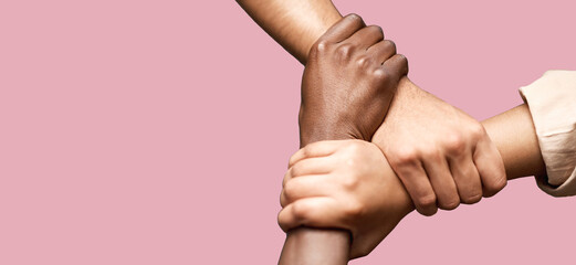 People, diversity and hands together in teamwork collaboration for trust against a pink studio...