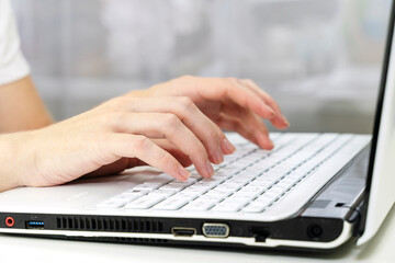 girl's hands on the laptop keyboard