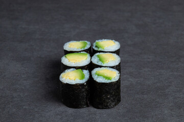 Sushi rolls on a black background, close-up, top view