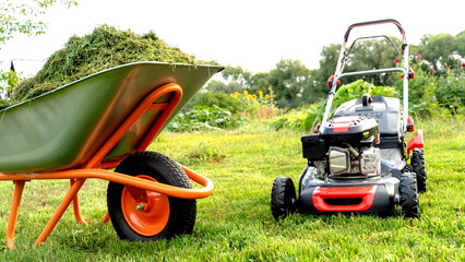 Lawn mover on green grass in modern garden. Machine for cutting lawns.