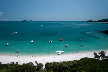 Aerial view of Whitehaven Beach with boats and a seaplane