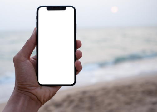 Hand holding black smartphone with transparent screen and beach see background , smartphone frameless application design concept and PNG file