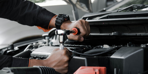 Mechanic fixing a car at home. Repair and service.