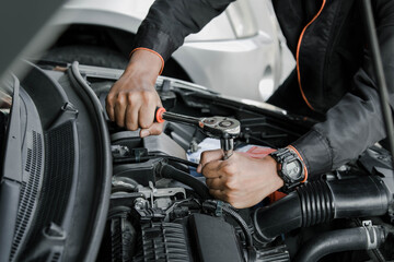 Mechanic fixing a car at home. Repair and service.